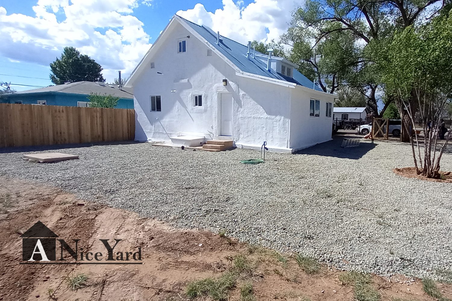 After — Tired exterior and a junked-up lot — cleaned, cleared, and refreshed.