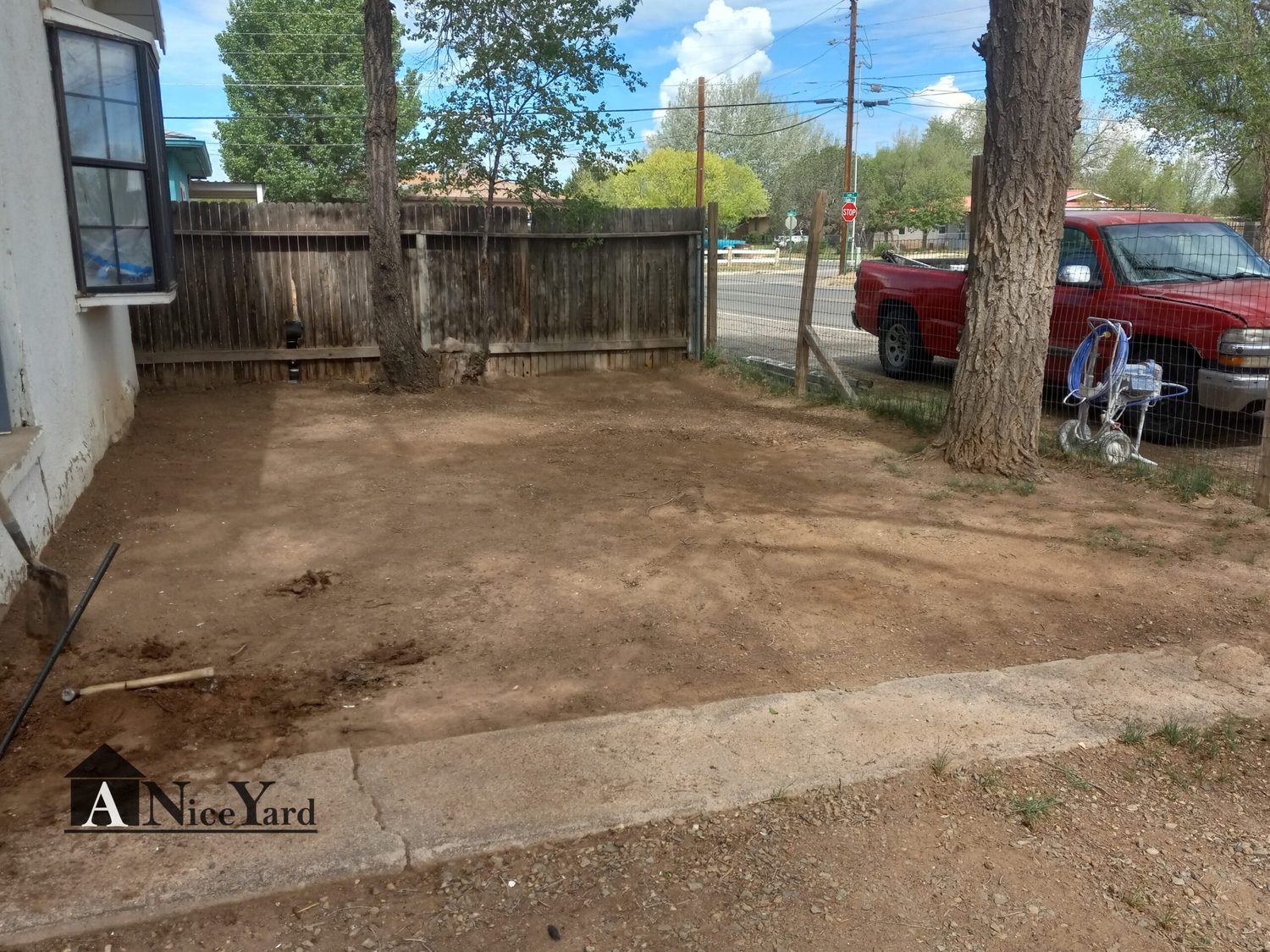 Before — Weeds and dirt replaced with clean gravel and mulched beds.