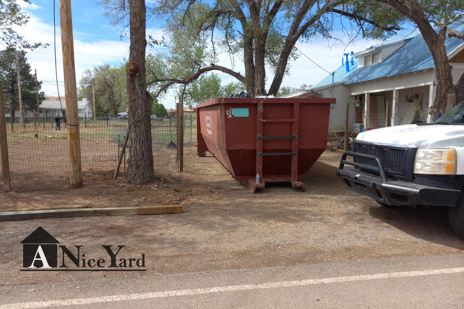 Before — Roll-off in, debris out, and a tidy graveled finish.
